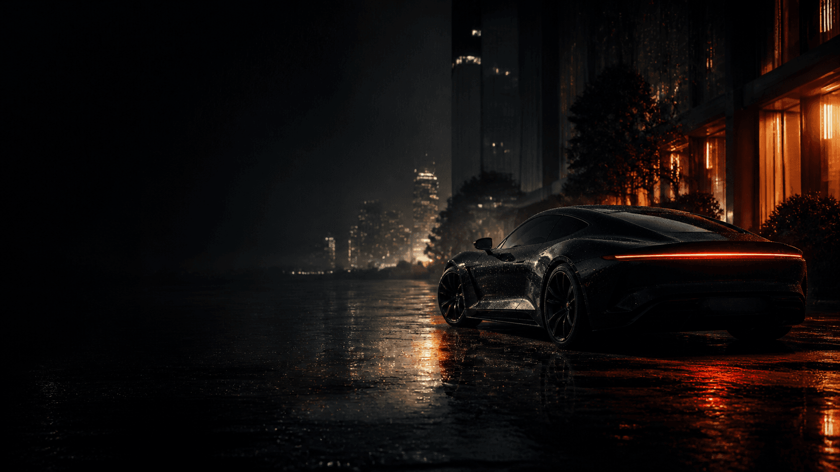 A dark concept vehicle resting in an orange-lit city after rain
